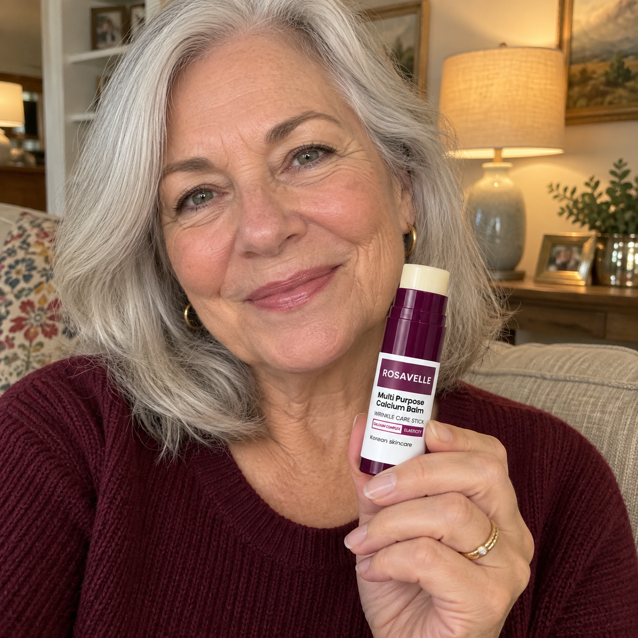 Woman holding Rosavelle balm in her living room