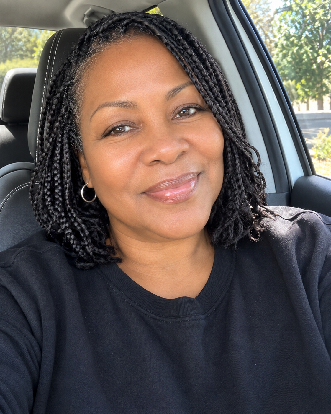 Illustrative selfie of a woman in a parked car